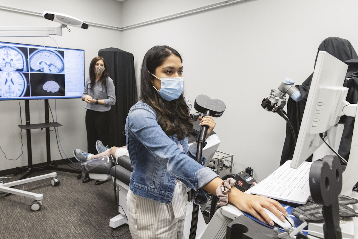 Scientists conduct research using EEG and TMS in the Koret Human Neuroscience Laboratory