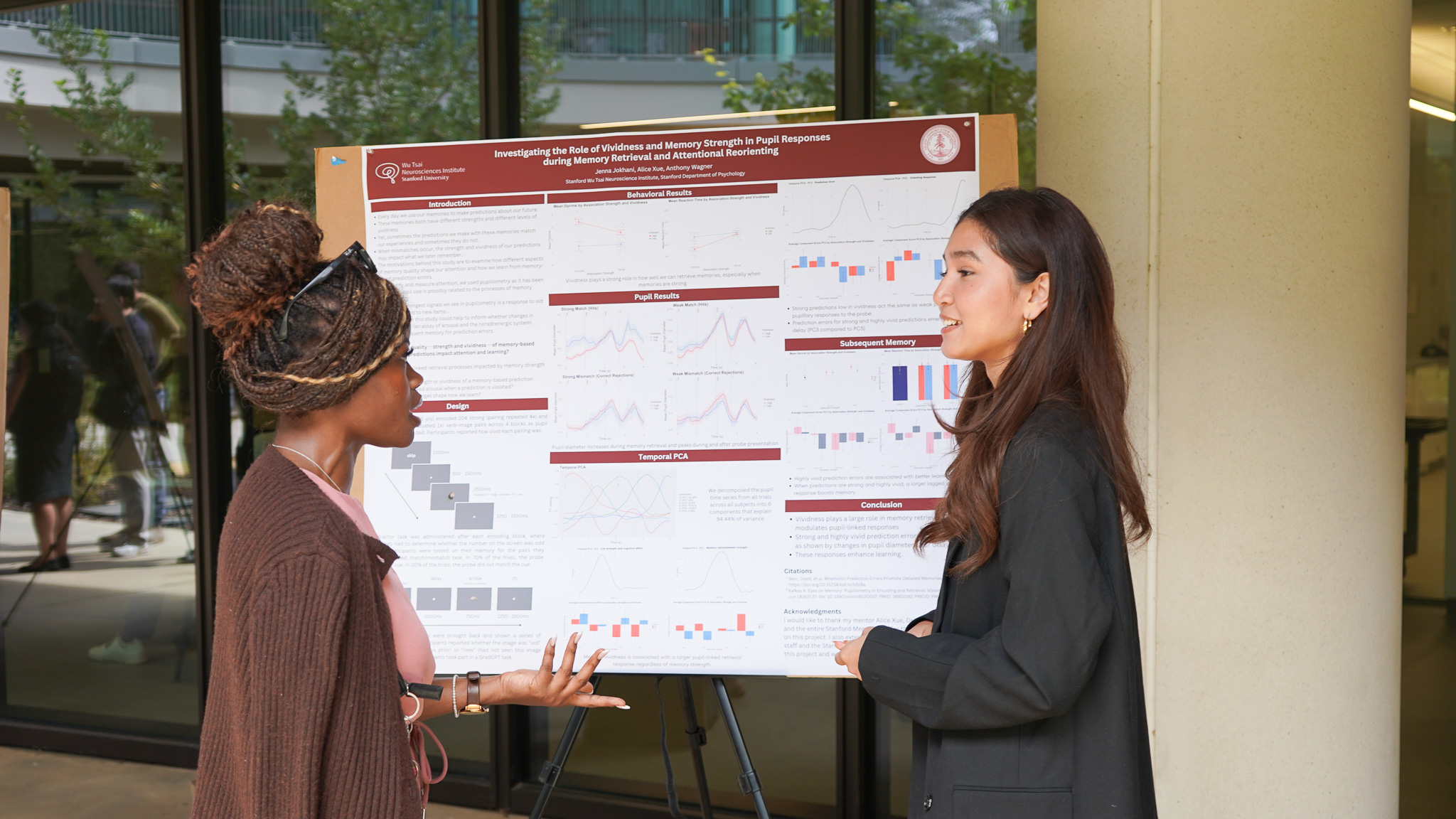 NeURO fellow Jenna Jokhani, discusses her research with NeuroTech Training Program alum Favour Nerrise at the poster session