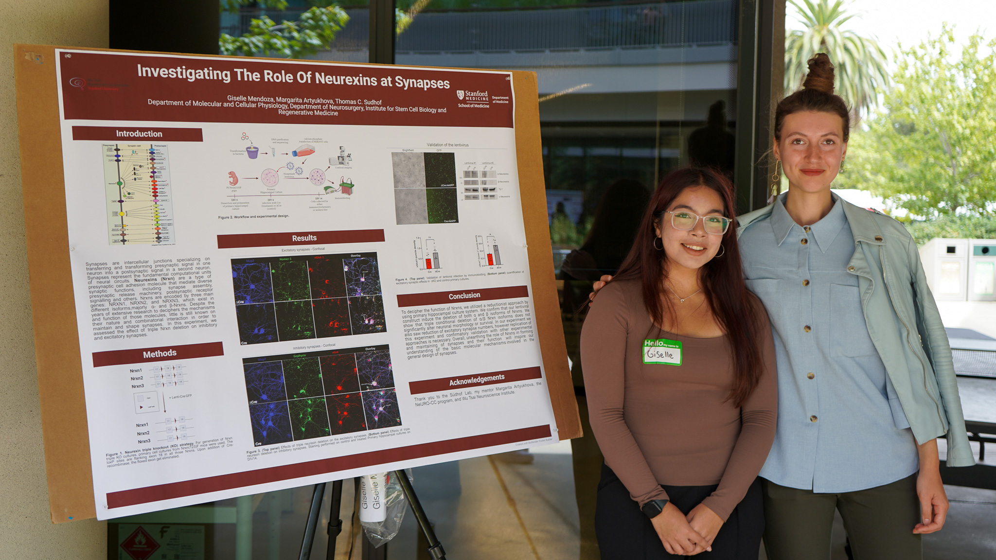 NeURO-CC Fellow Giselle Mendoza stands beside her summer research poster from the Sudhof Lab with her mentor, Margarita Artiukhova