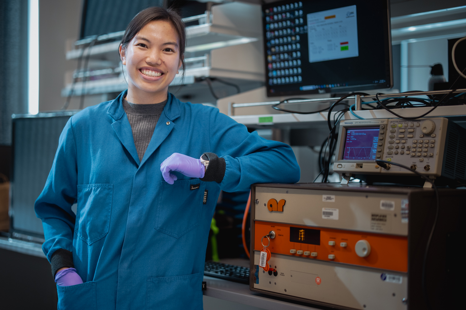 Graduate student Marigold Malinao with research equipment in the Guosong Hong lab 