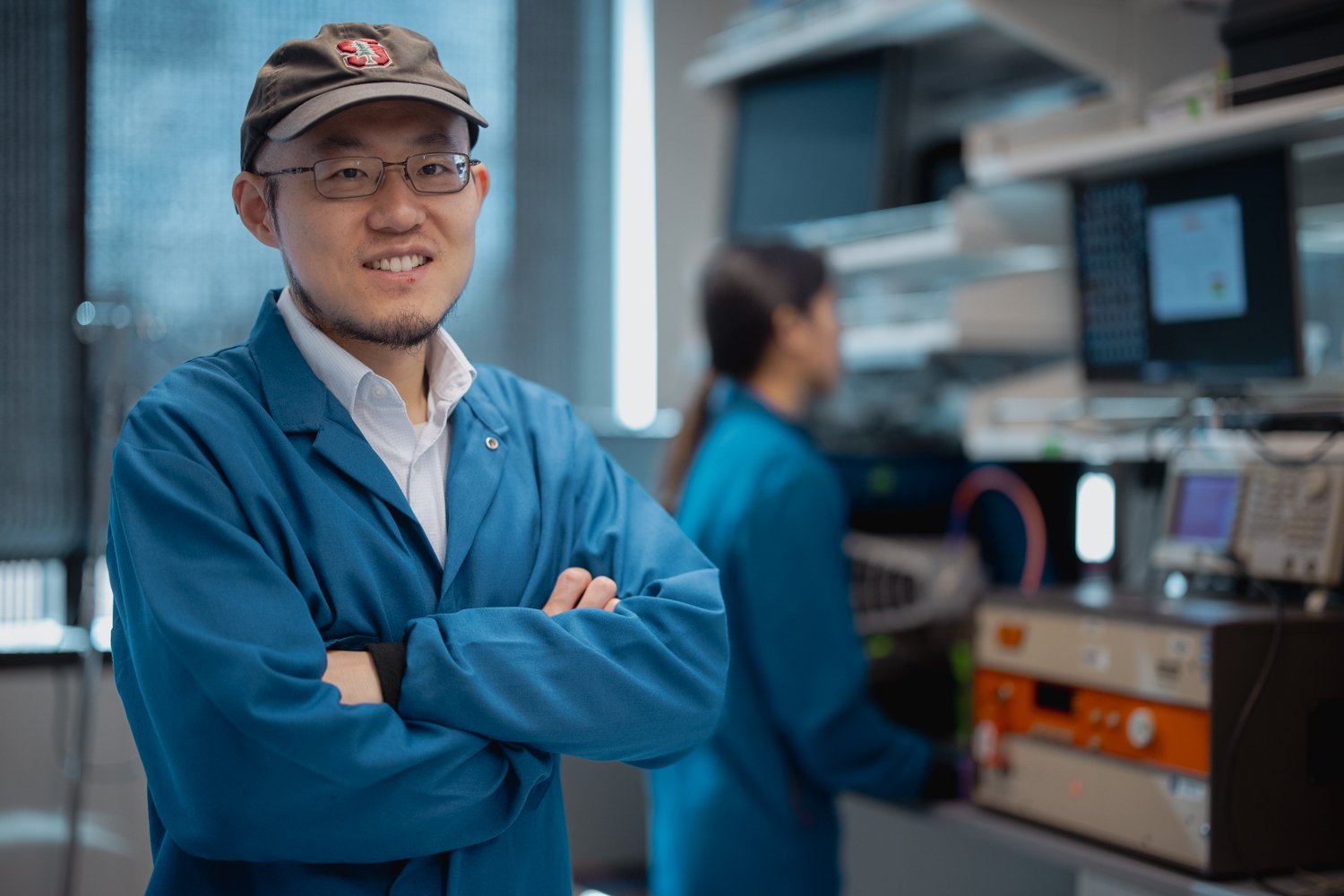 Guosong Hong and a student in his lab