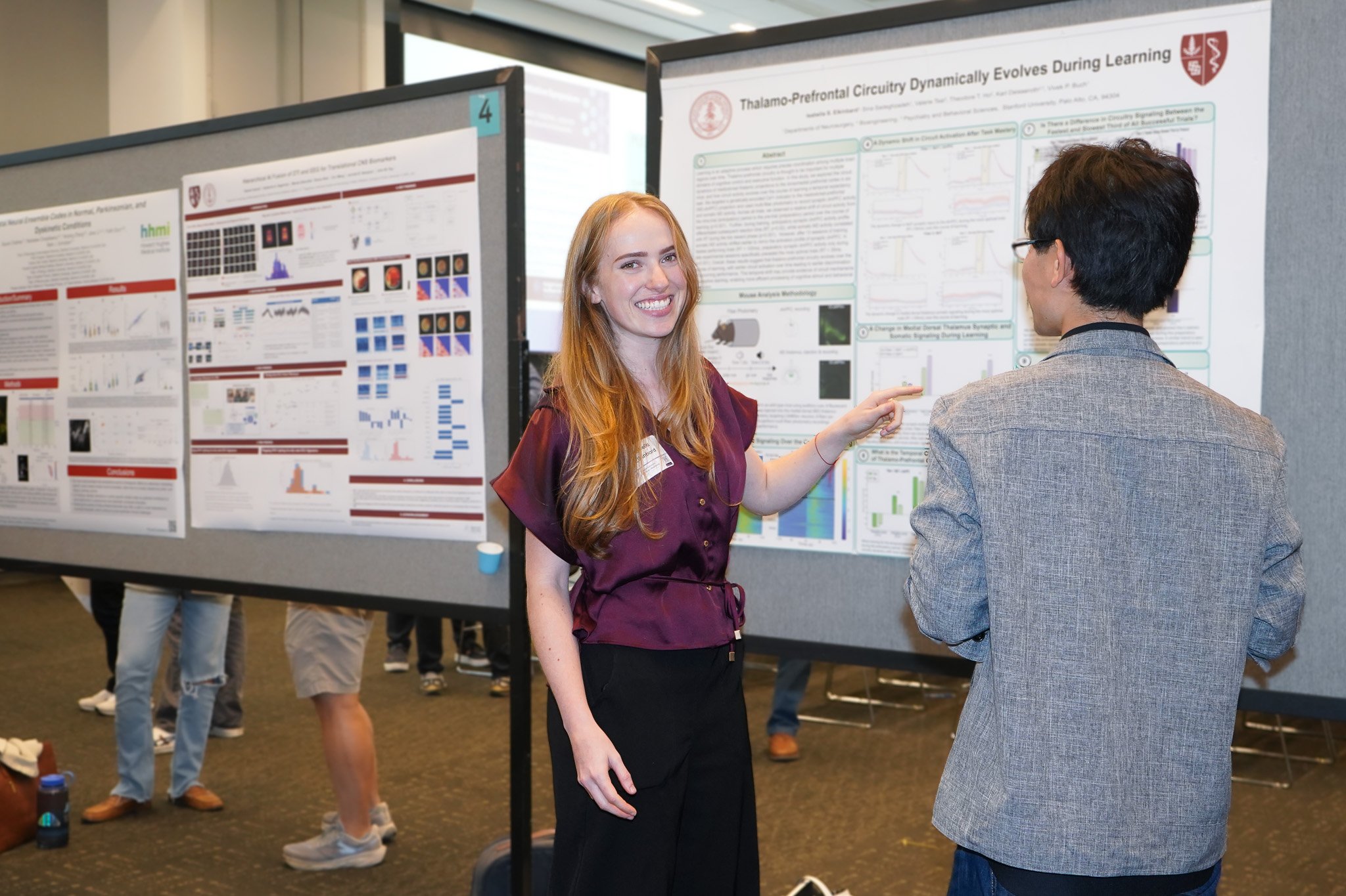 Isabella Elkinbard presents her research at a poster session.