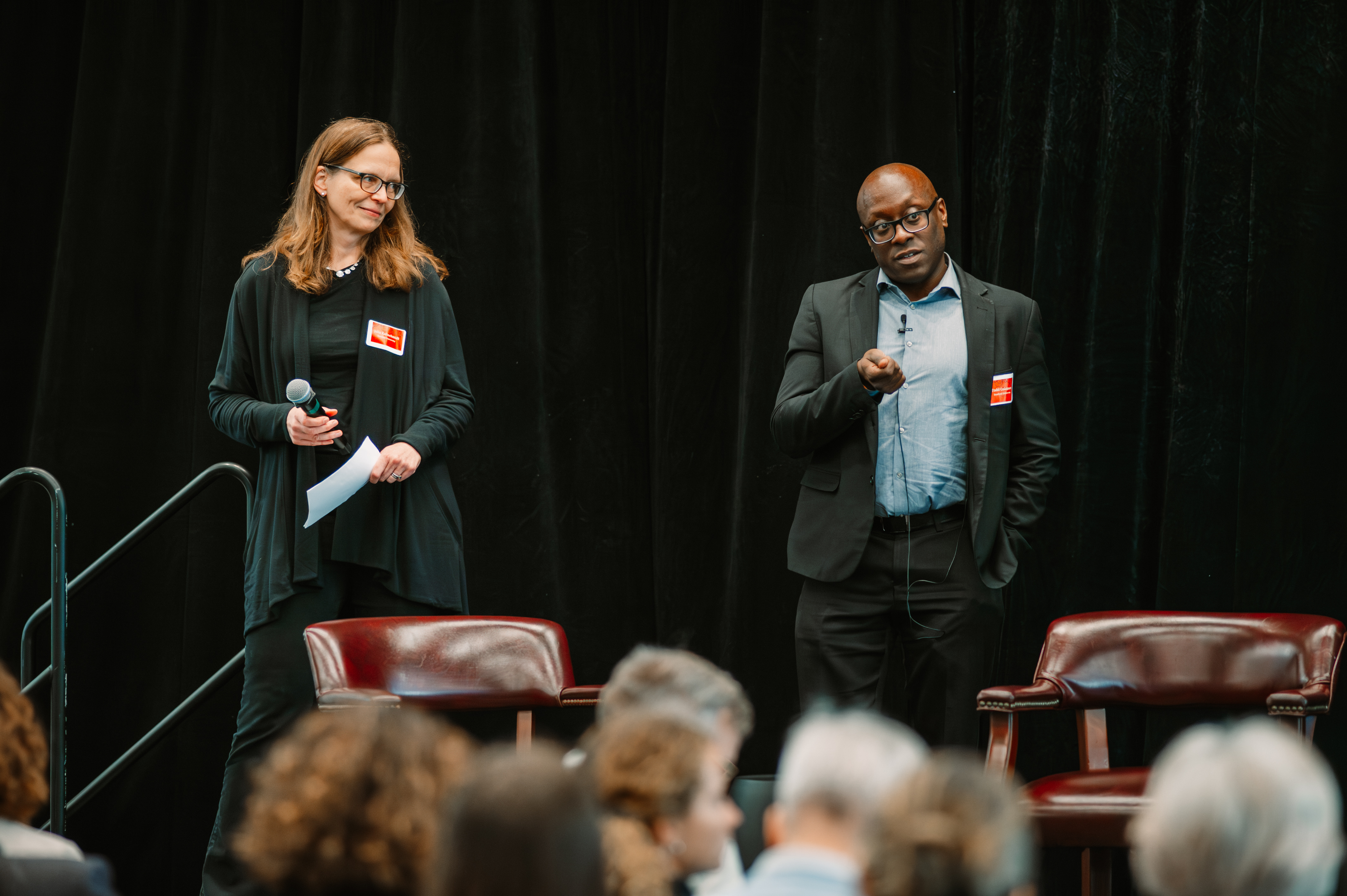 Julia Kaltschmidt and Todd Coleman speak before an audience.