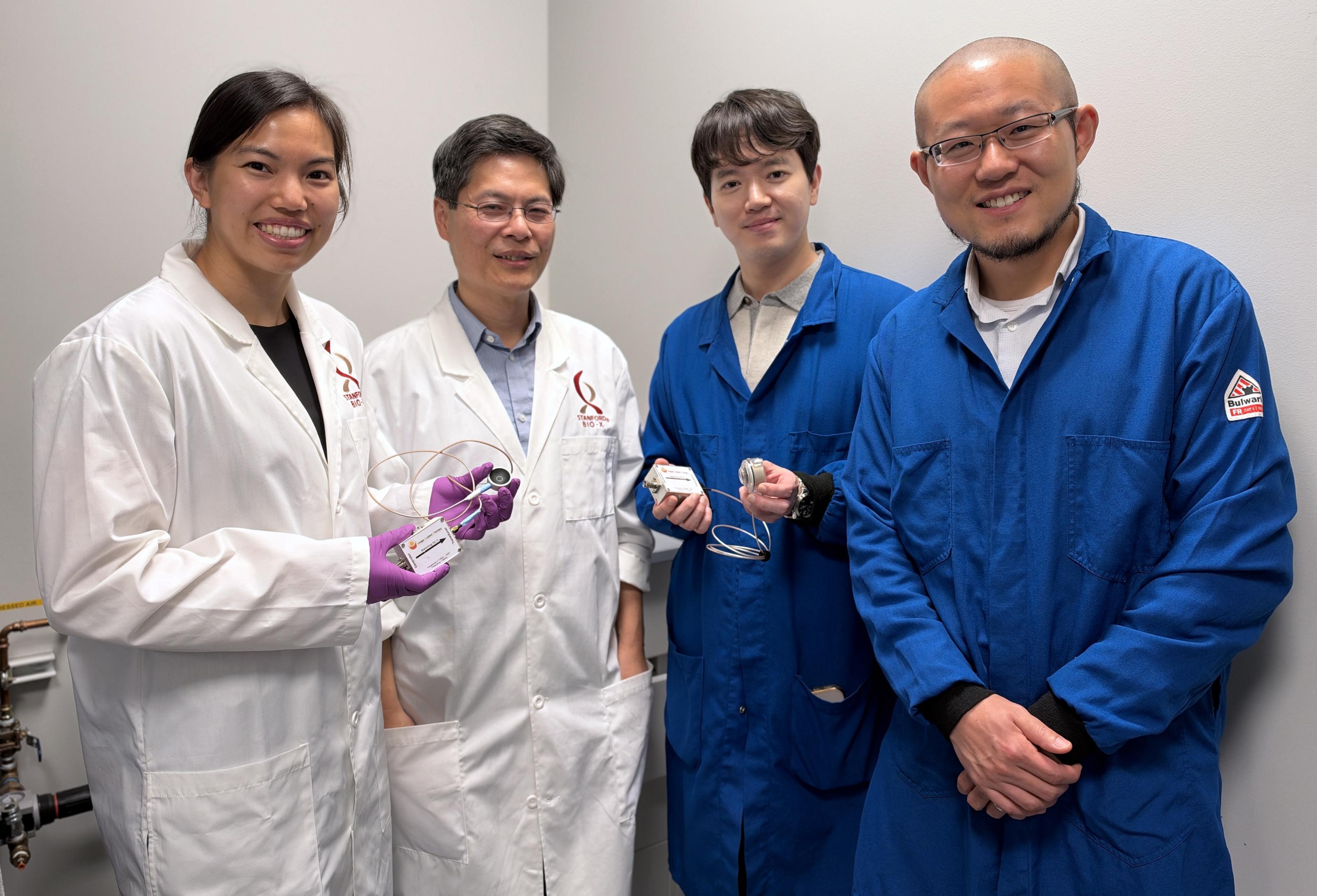Marigold Gil Malinao, Michael Lin, Daesun Song, and Guosong Hong hold up ultrasound devices.