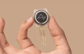 Image of a hand holding a neuralink device