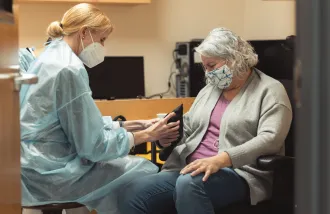 Postdoctoral researcher Caitlyn Seim takes measurements with a participant in the clinical trial. (Image credit: Andrew Brodhead)