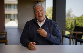 Video still showing scientist James Doty talking at a table