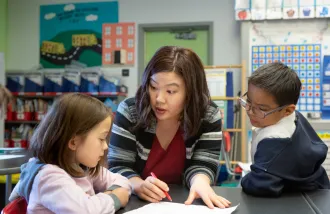 Teacher with students in elementary school classroom