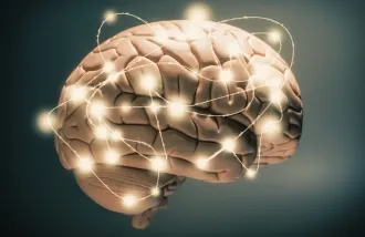 Stock image of a brain with circuits around it