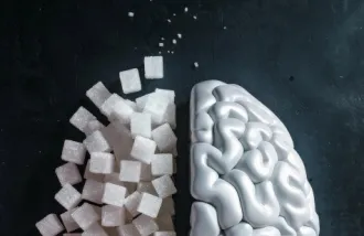 Stock image of a brain in which the left hemisphere is made up of sugar cubes; white on black background
