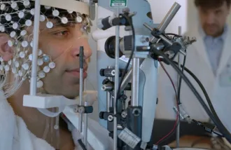 Karl Deisseroth (at right) supervising a demonstration of the eye puff test (with non-contact tonometry equipment) as used in his recent paper studying emotions and related brain activity in human beings.