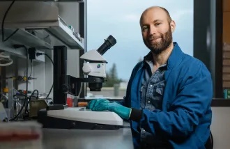Blake Laham works at a microscope in his lab.