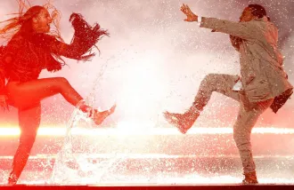 Stock photography of man and woman dancing with dramatic water splashing effect