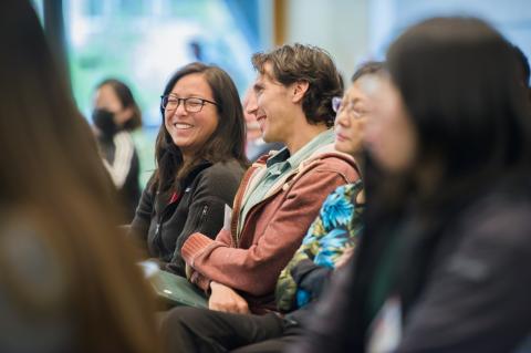 Audience members smile at Wu Tsai Neuro's 10th Annual Neurosciences Symposium