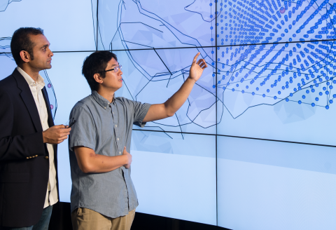 Mentor and trainee discuss science on a screen