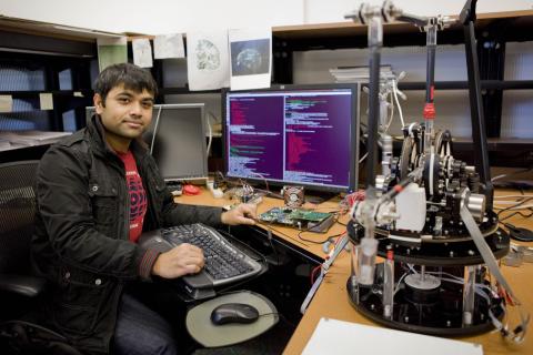 Trainee works on neurotechnology research at a desk 