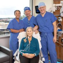 Debbie Styles smiles with her surgical team. Standing, from left to right: Tiffany, a research coordinator for the CARDIAC-PND Study, Dr. Martin Angst, and Dr. Igor Feinstein. 