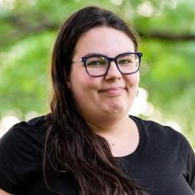 Shannon Pagdon headshot with leafy branch in background