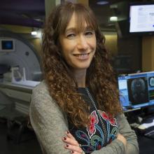 Kalanit Grill-Spector in front of an MRI scanner