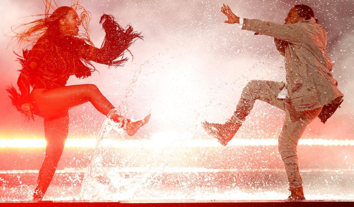 Stock photography of man and woman dancing with dramatic water splashing effect