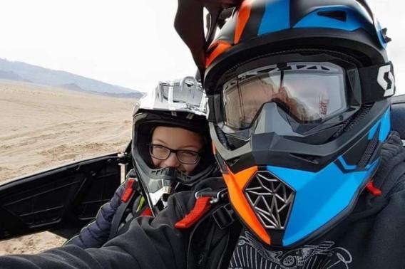 In this 2019 photo, Timothy syndrome patient Holden Hulet, left, rides in a side-by-side ATV driven by his dad, Kelby Hulet, at sand dunes near their home in southern Utah. 
