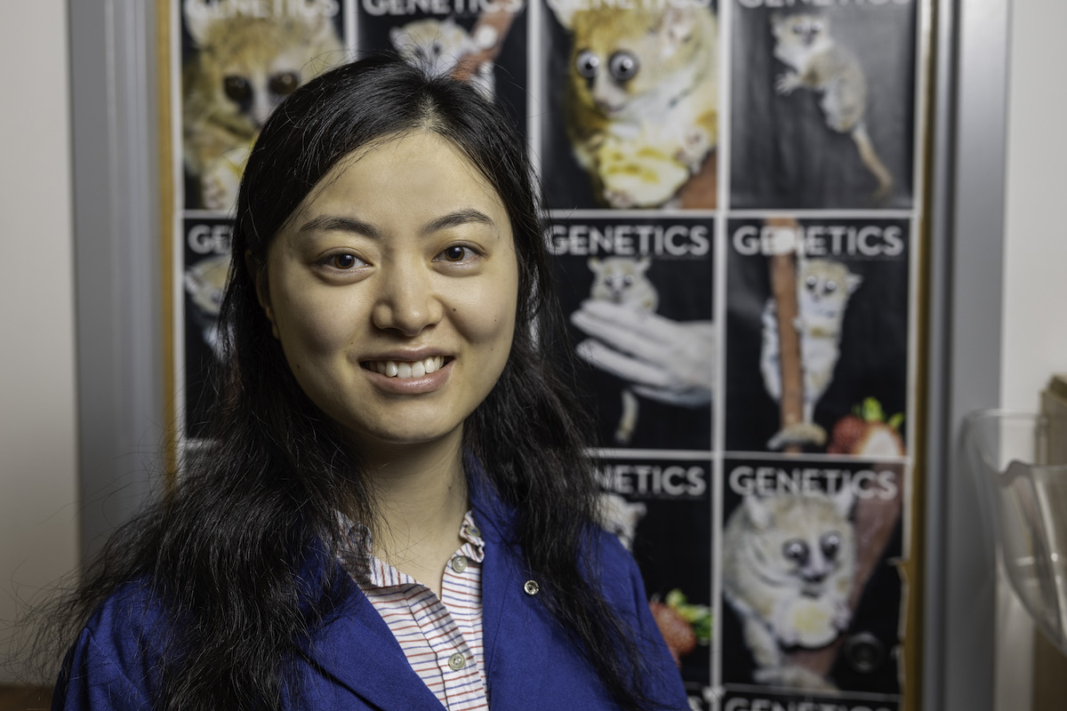 Wu Tsai Neurosciences Institute Interdisciplinary Scholar Shixuan Liu poses with photos of the mouse lemur